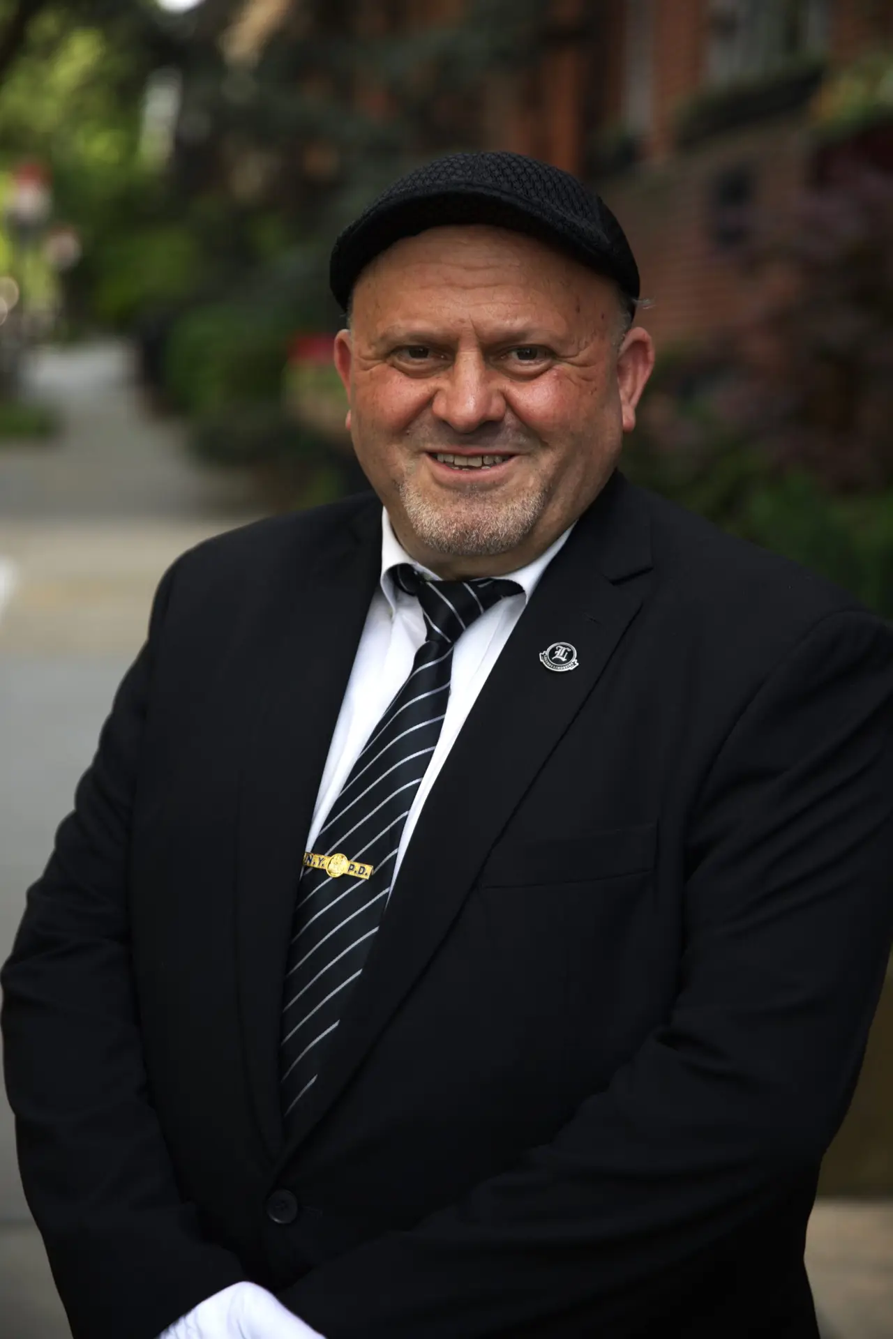 Legends Limousine Worldwide NYC Car and Limo Service Chauffeur Smiling in NYC New York Neighborhood - Best NYC Car Service
