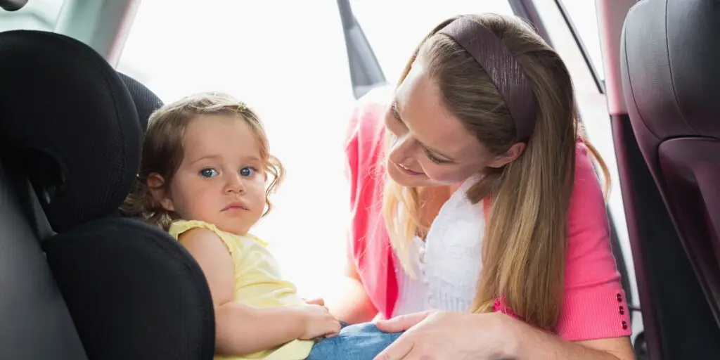 Happy mom with her baby in a car seat using car and limo service - Legends Limousine - Best Car & Limo Service in New York with a Car Seat