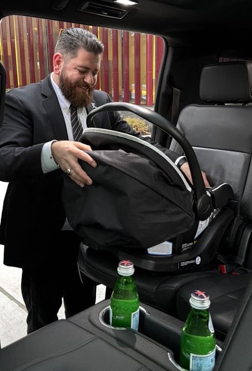 Legends Limousine chauffeur installing a child car seat in an SUV in NYC